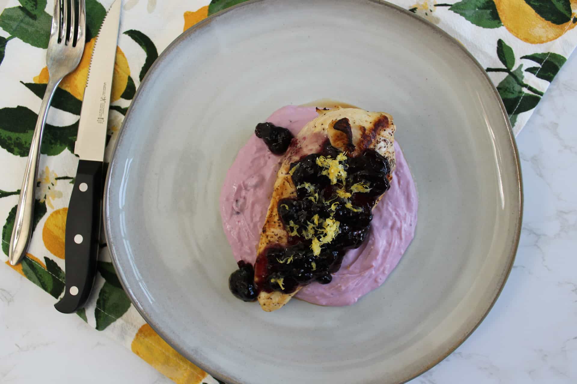 A plate of blueberry lemon goat cheese chicken