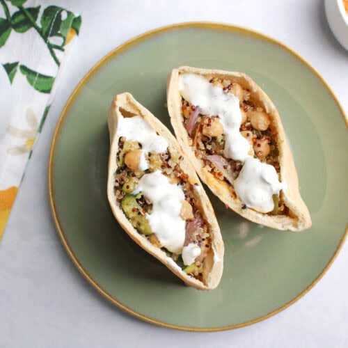 Two pita pockets with Mediterranean roasted vegetables and chickpeas.