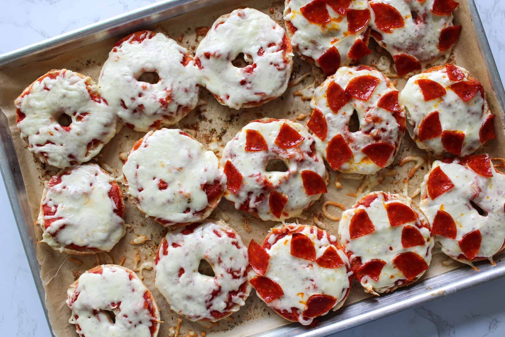 A sheet pan of homemade mini pizza bagels