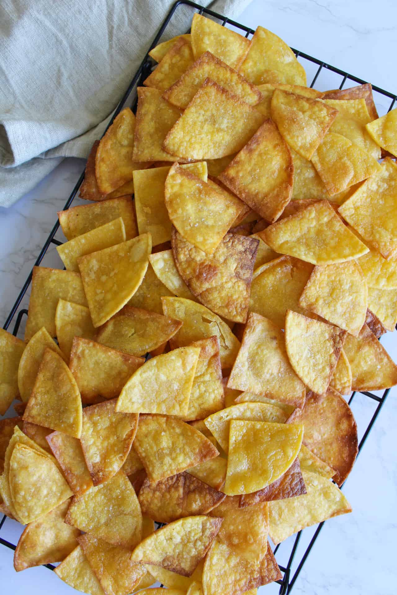 Homemade corn tortilla chips on a cooling rack