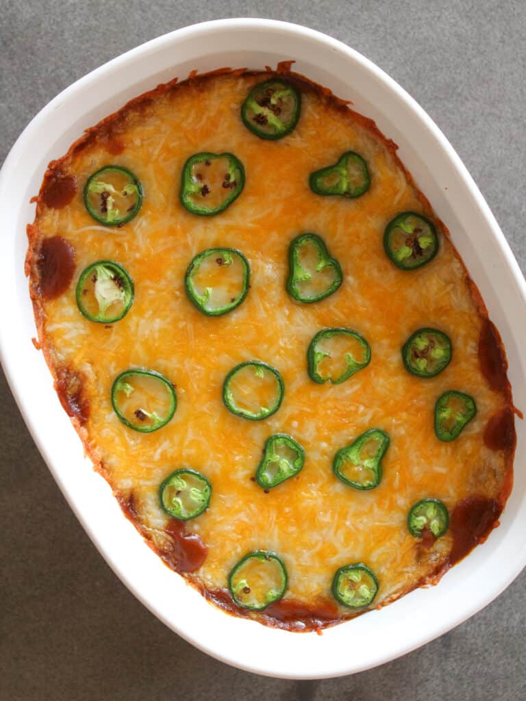 4 layer Mexican dip in a baking dish.