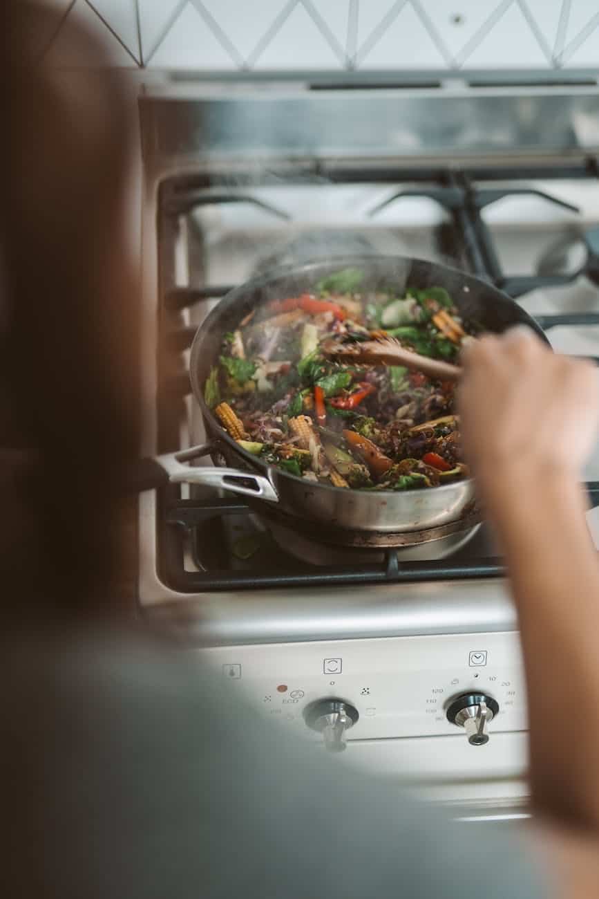 A person cooking stir fry.