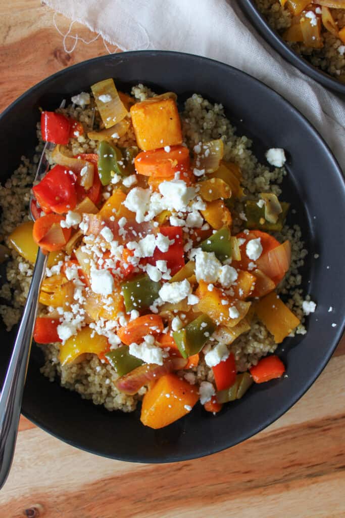A fall harvest bowl with quinoa, veggies, and feta.