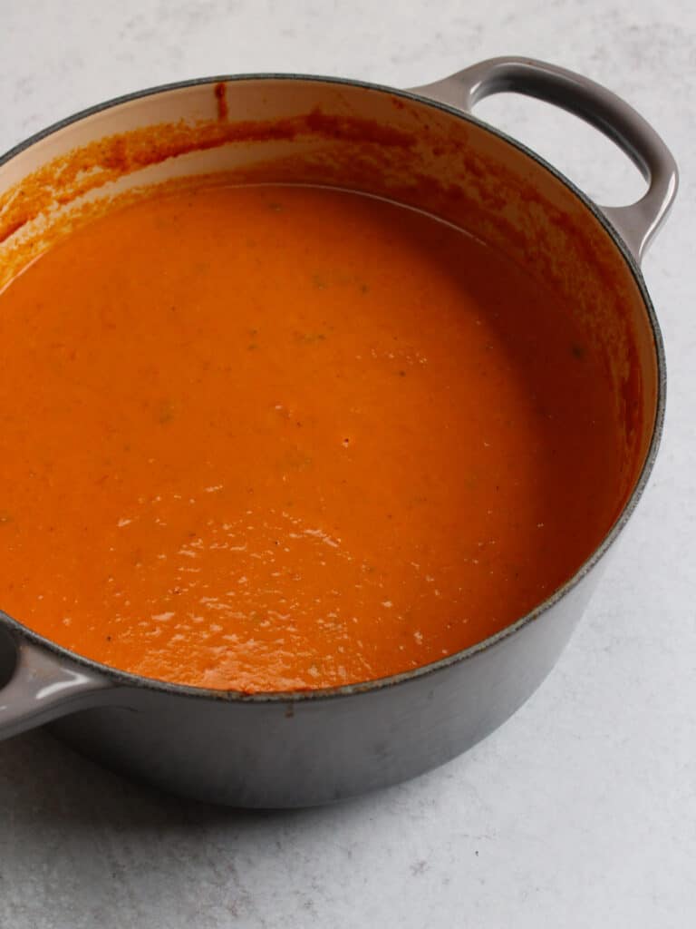 A large pot of Indian style spicy tomato soup.