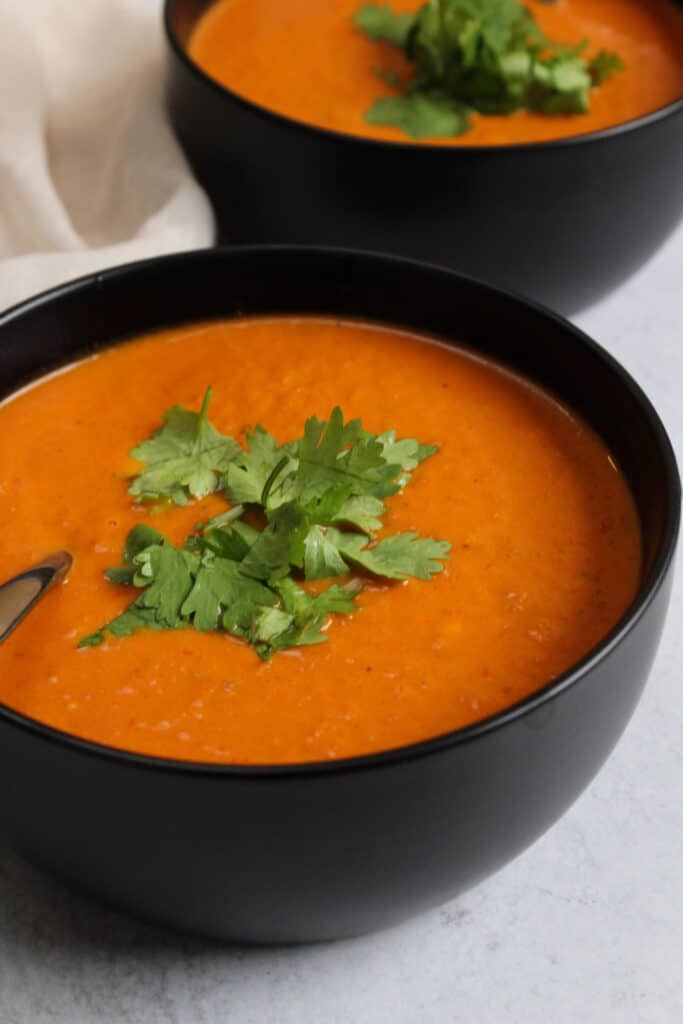 Indian spiced tomato soup garnished with cilantro.