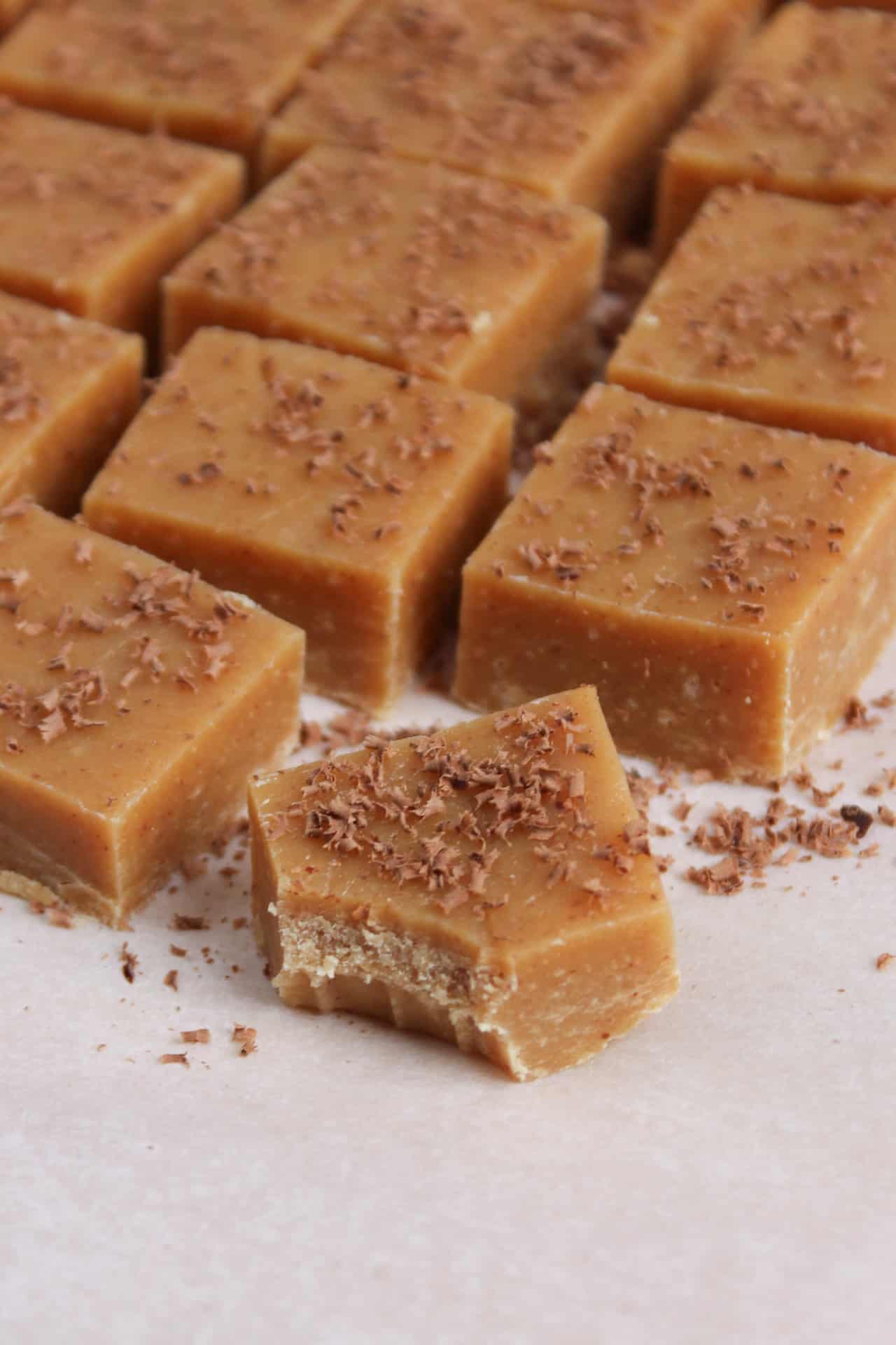 Peanut butter fudge squares dusted with dark chocolate shavings.