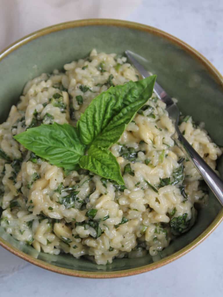 Deconstructed basil pesto risotto in a bowl.