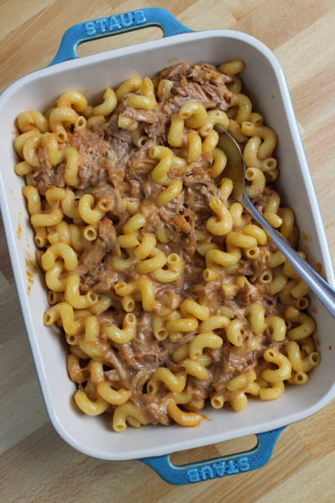 A baking dish of bbq pulled pork mac and cheese.