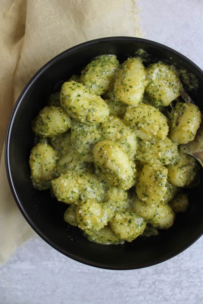 A bowl of pesto parmesan gnocchi.