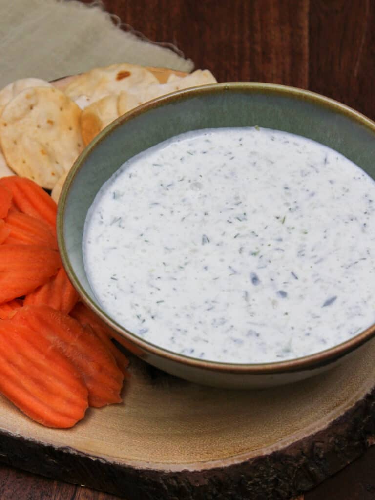 Greek tzatziki sauce served with carrots and pita chips.