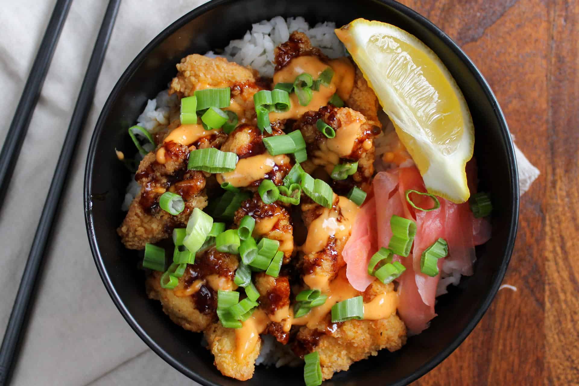 A Japanese inspired crispy chicken and rice bowl with lemon and pickled ginger.