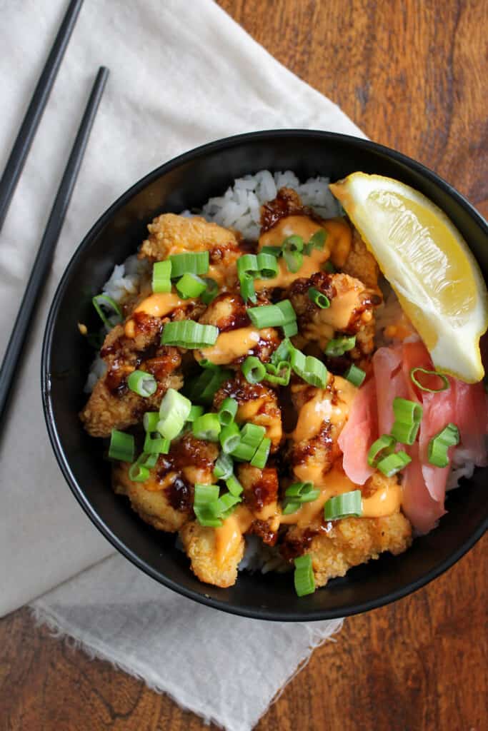 Japanese inspired crispy chicken bowl with rice and pickled ginger.