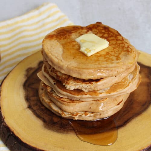 A stack of buttermilk protein pancakes on a plate.