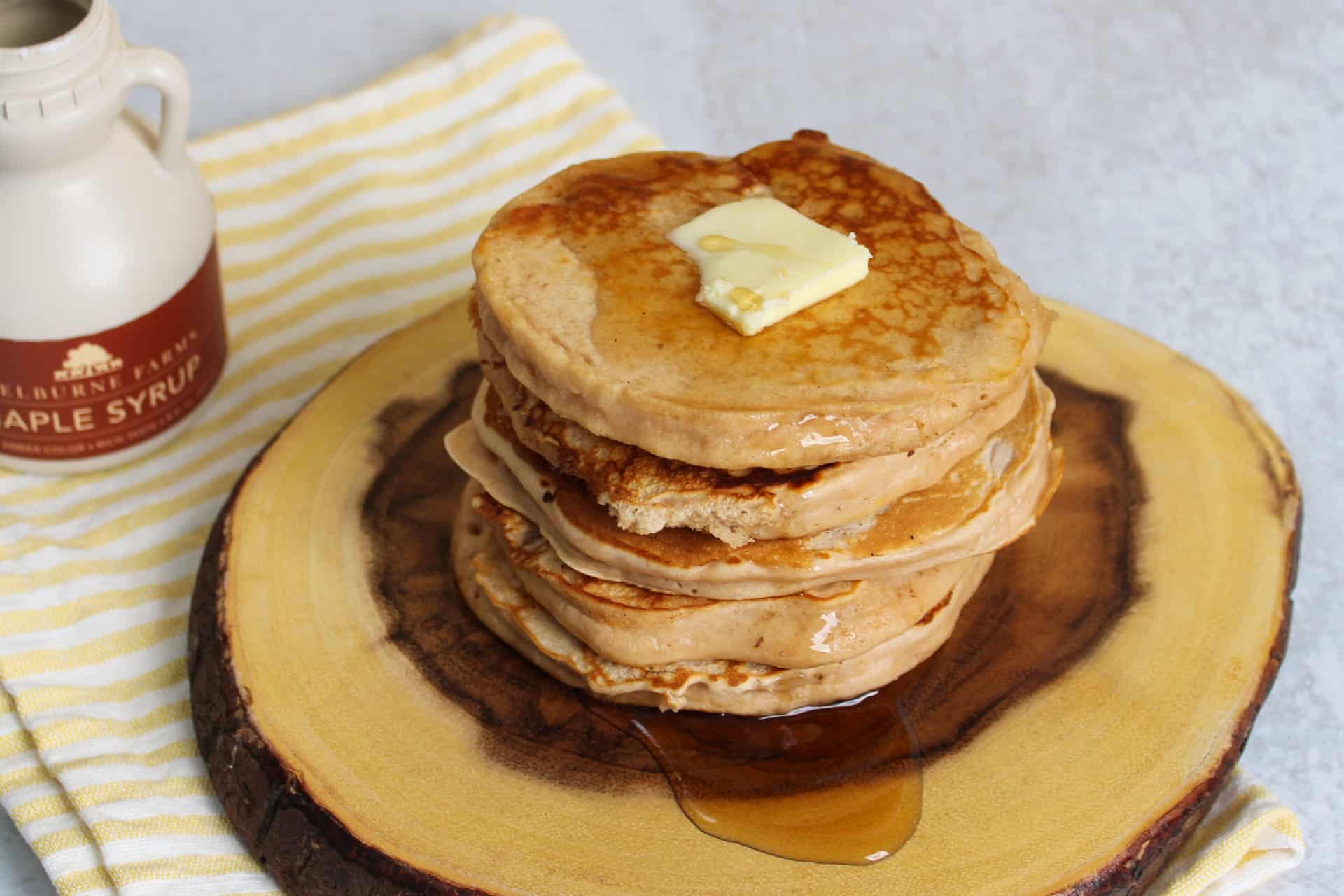 A stack of buttermilk protein pancakes on a plate.