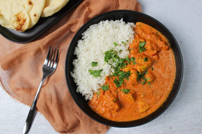 Spicy Indian butter chicken with rice and naan.