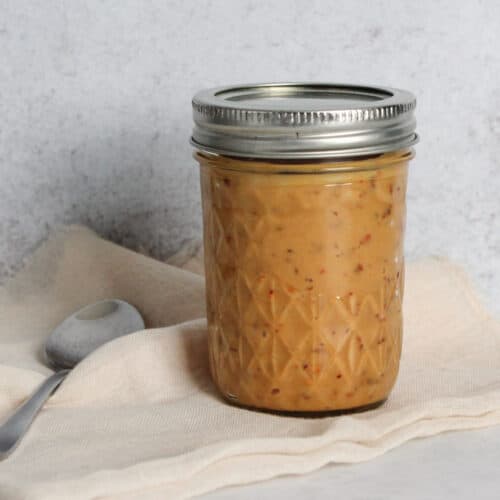 A jar of spicy cashew dressing.