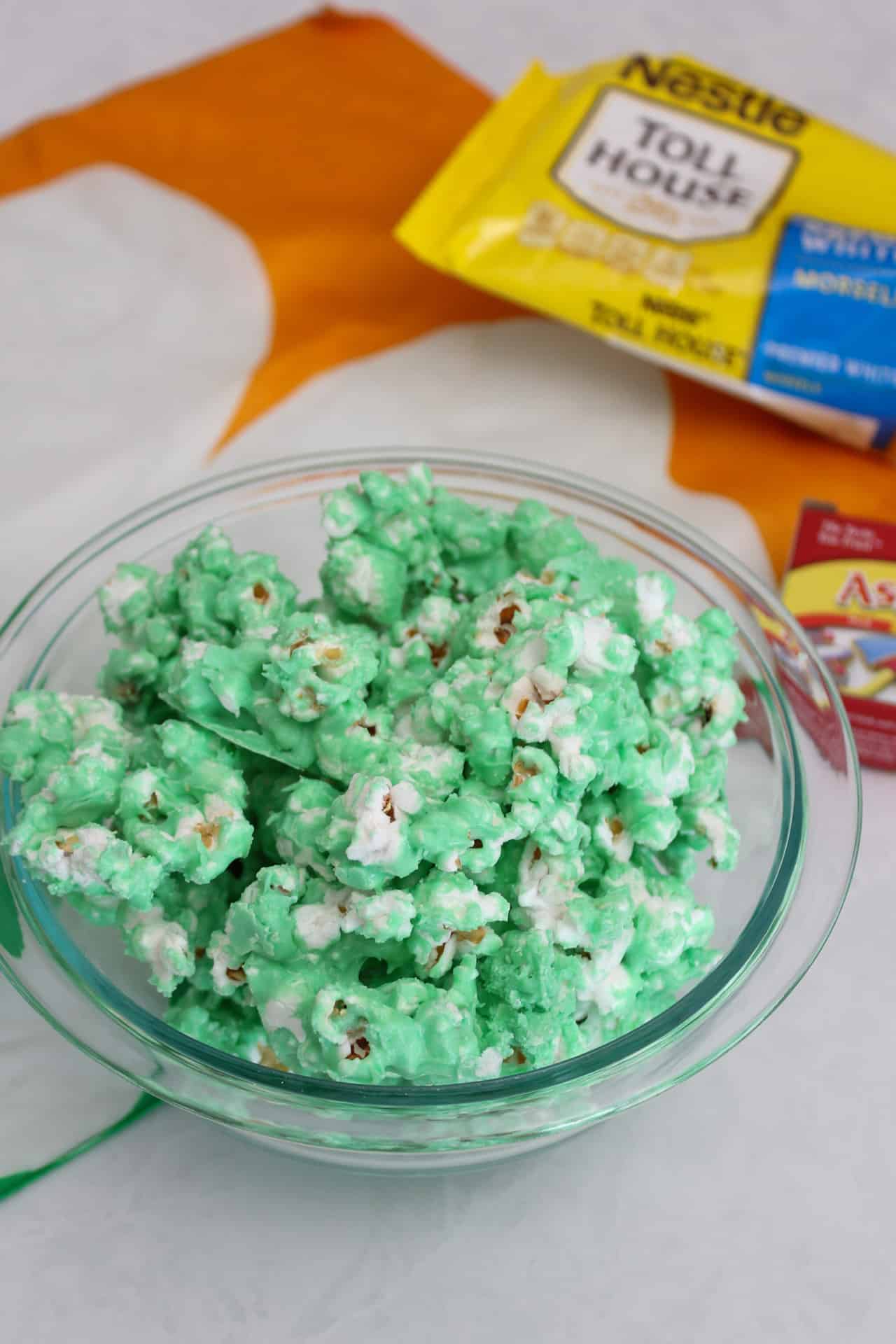 Green chocolate covered popcorn in a pyrex bowl for St. Paddy's Day.