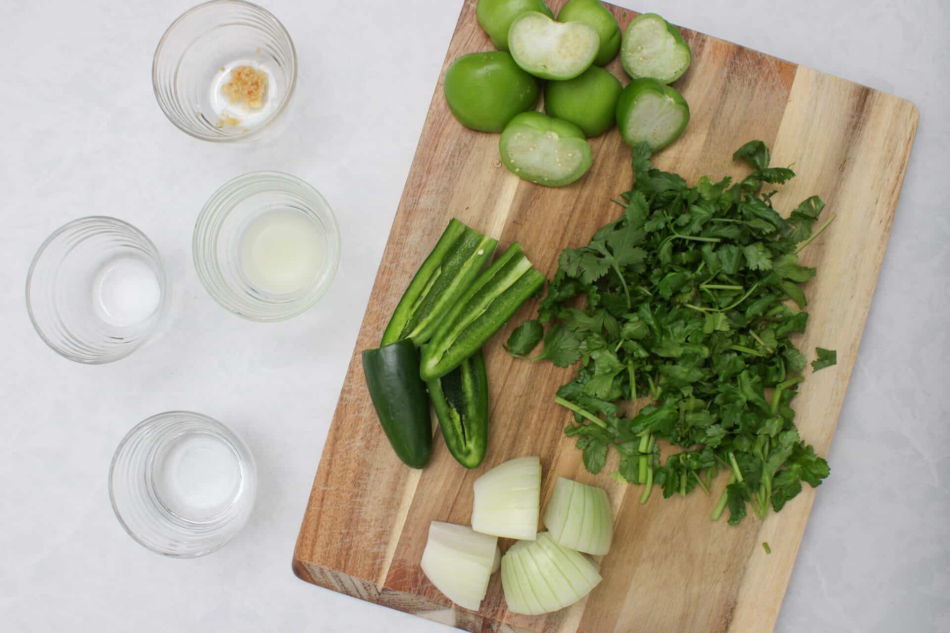 Mise en place ingredients for a salsa verde.