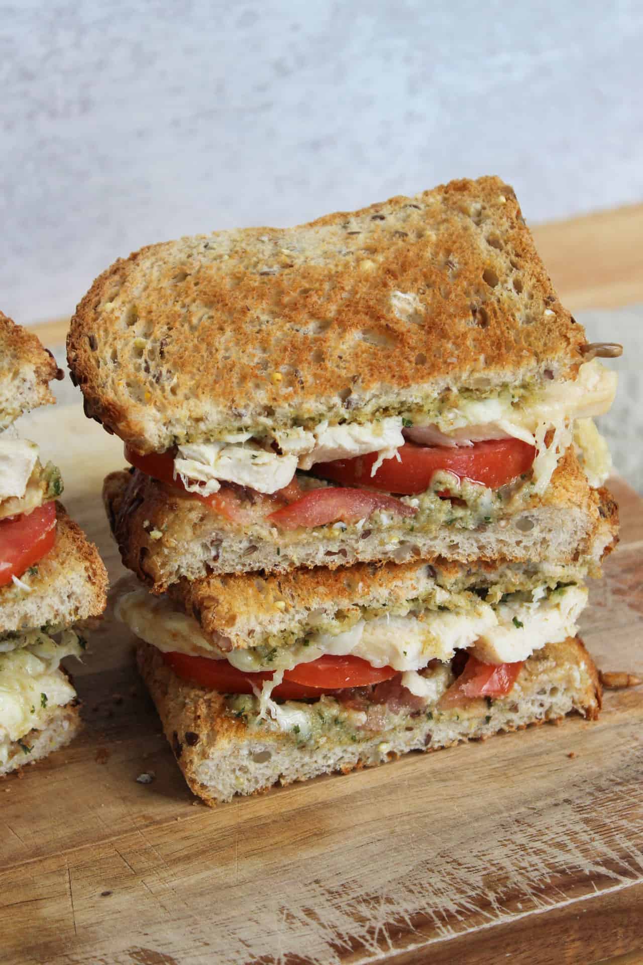 Two halves of a sandwich stacked on a plate.
