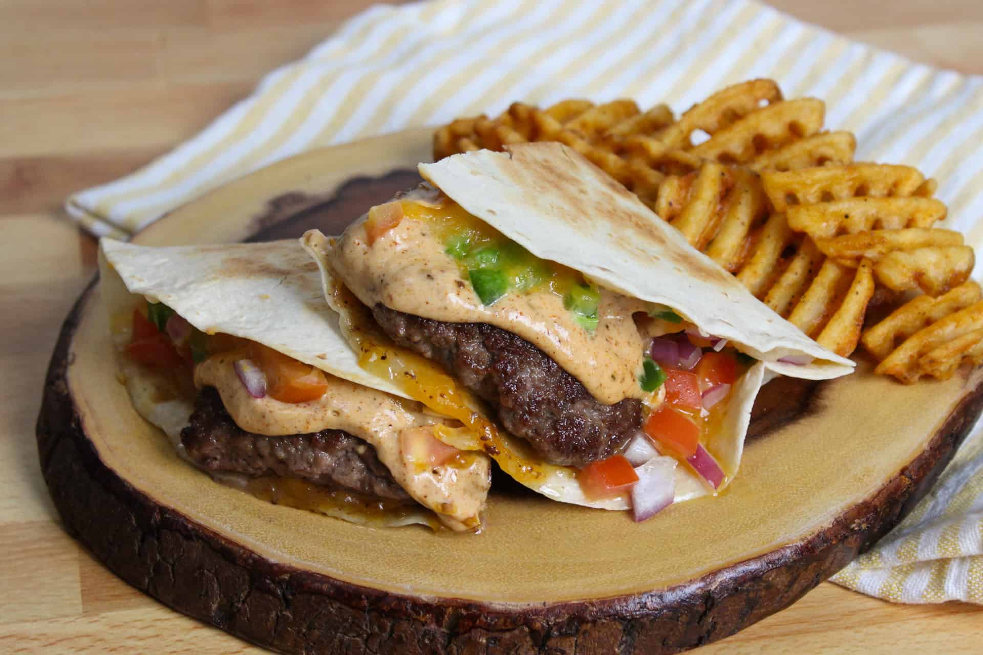 A quesadilla smash burger on a plate.