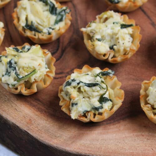 Mini phyllo shells filled with spinach artichoke dip.