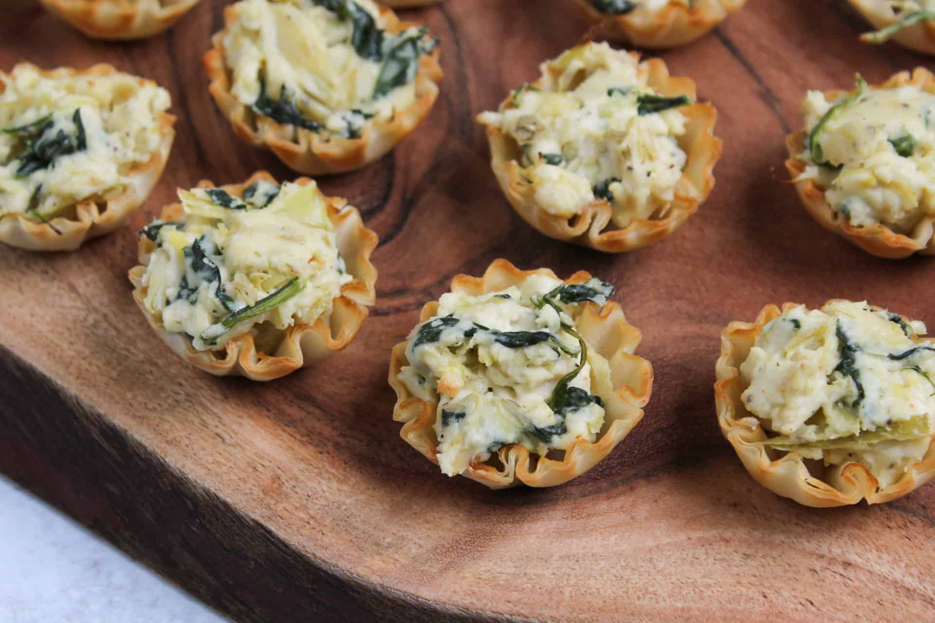 Mini phyllo shells filled with spinach artichoke dip.