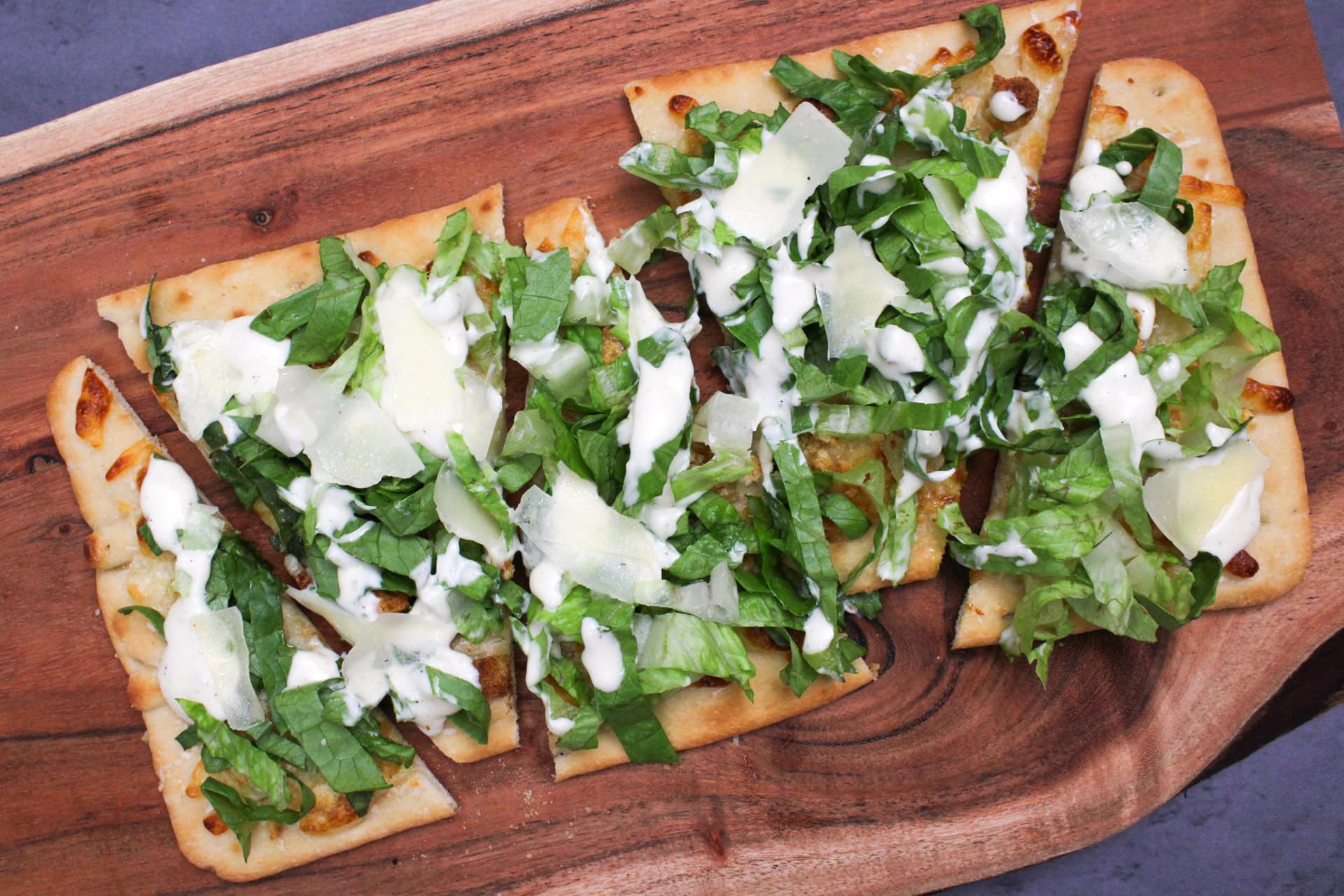 A Caesar salad flatbread pizza.