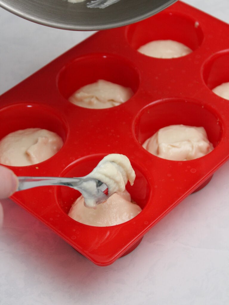 How to make mini cheesecakes: adding the filling.