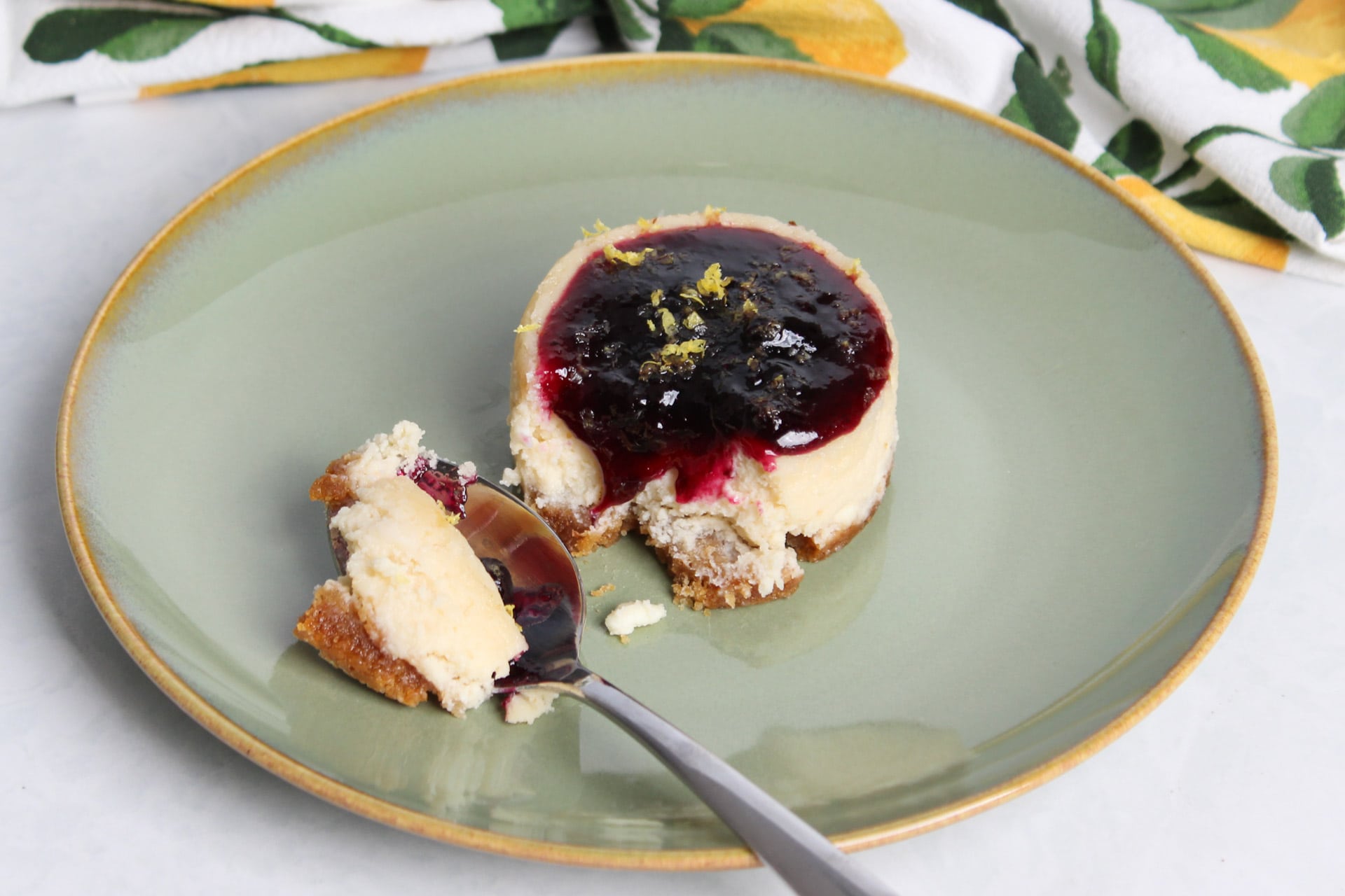 A mini cheescake with a bite taken out.