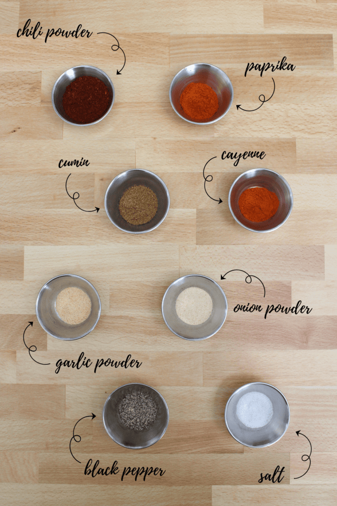 Ingredients for making taco seasoning: chili powder, paprika, cumin, cayenne, garlic powder, onion powder, black pepper, and salt.