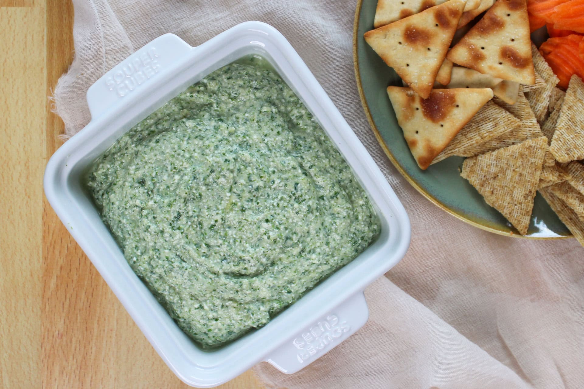 Spinach artichoke dip with crackers.