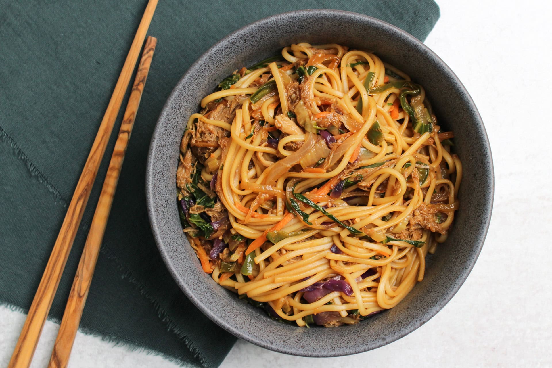 Pork stir fry with lo mein noodles and vegetables.