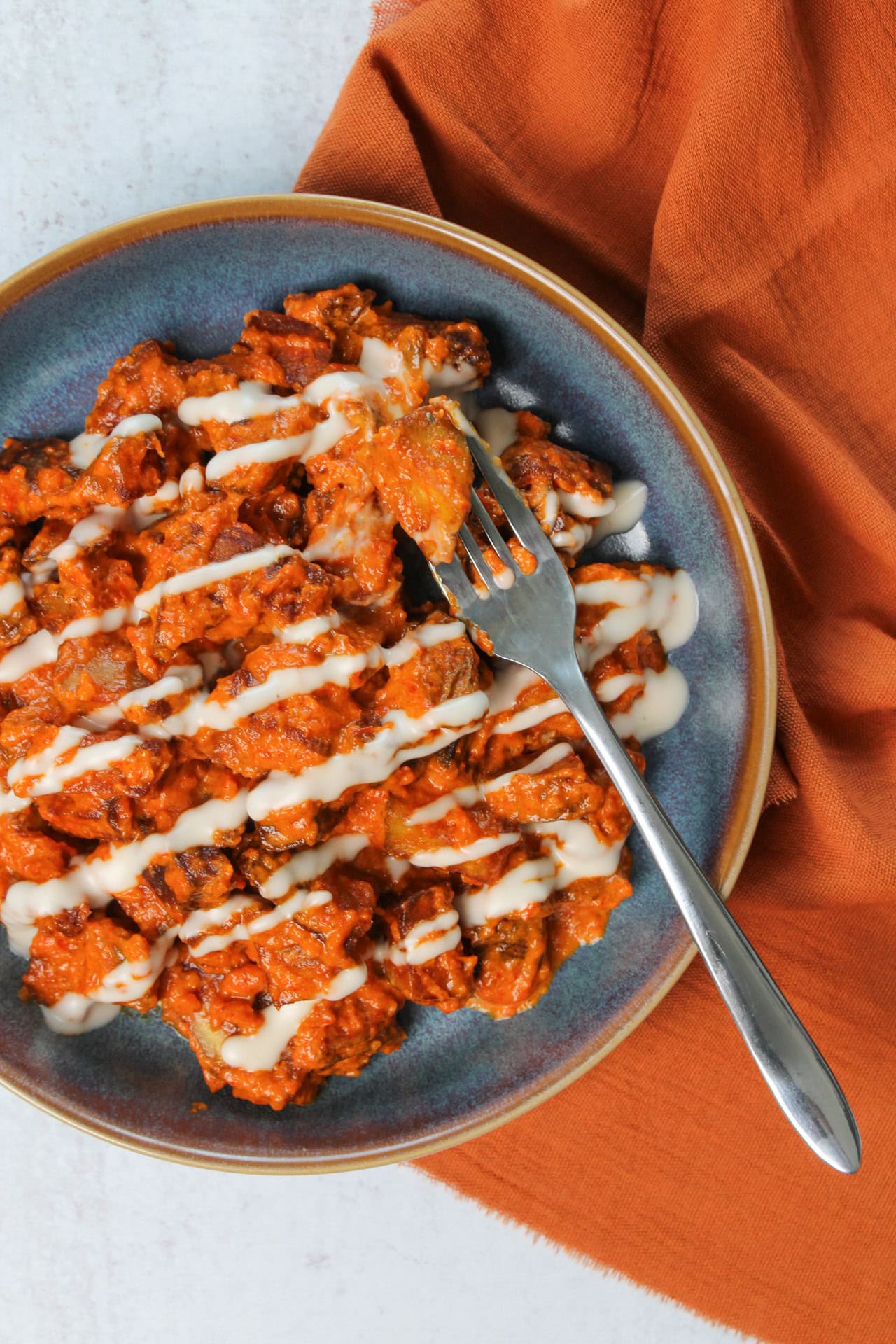 Patatas bravas drizzled with garlic aioli.