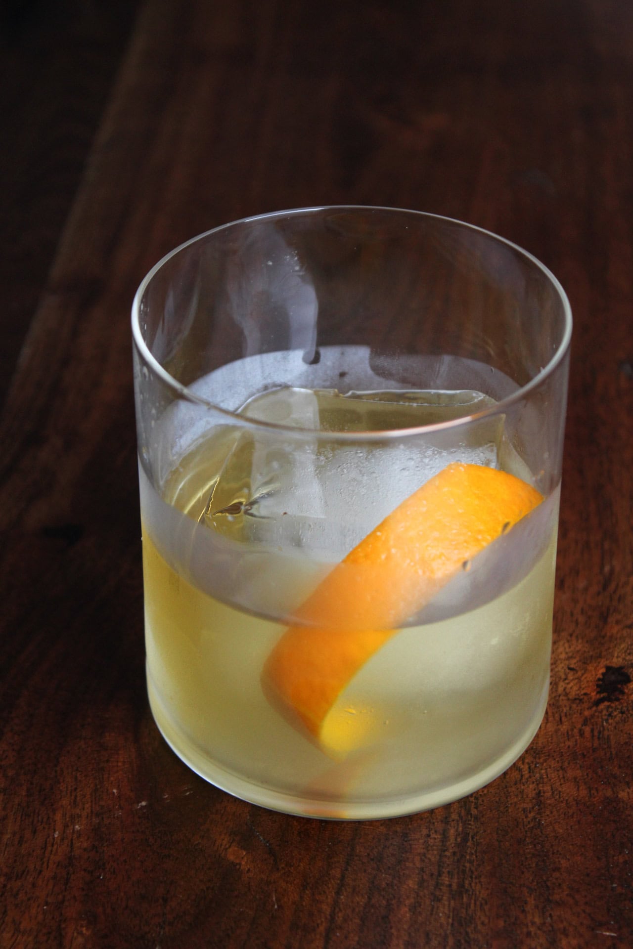 A mezcal old fashioned in a rocks glass.
