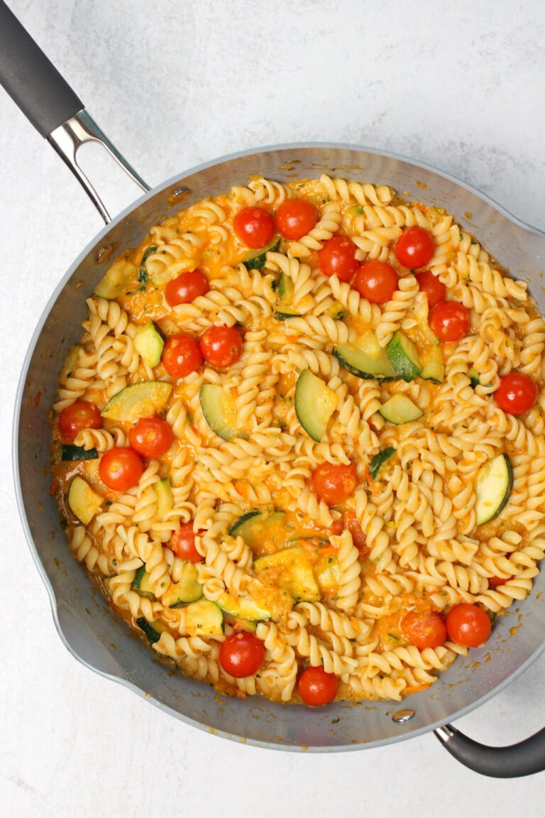 Zucchini and tomato pasta in a skillet.