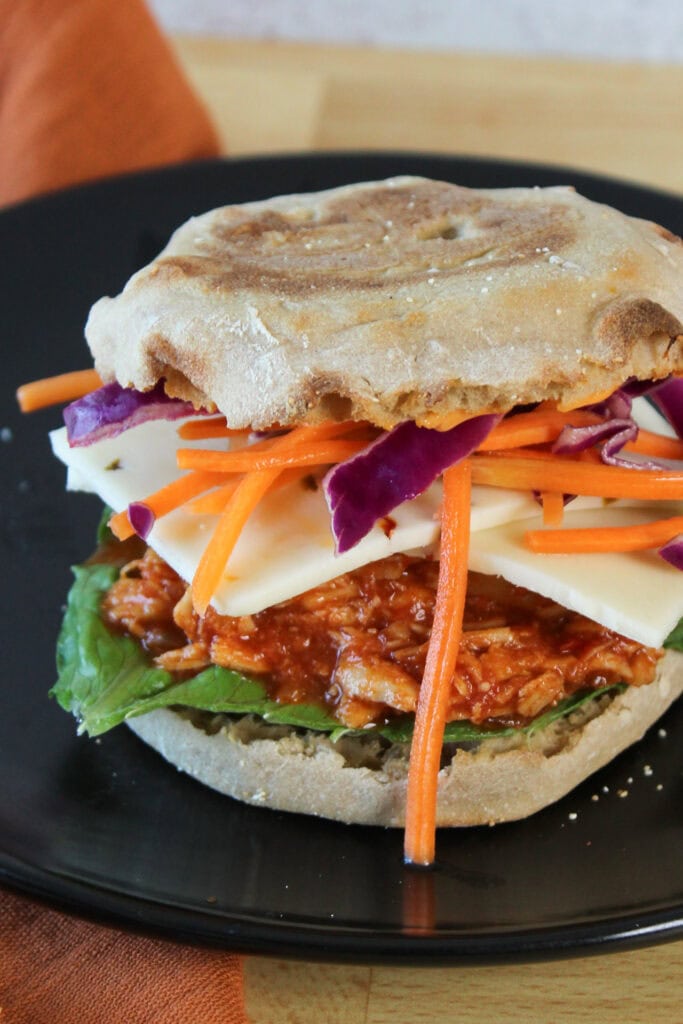A Gochujang chicken sandwich on english muffin.