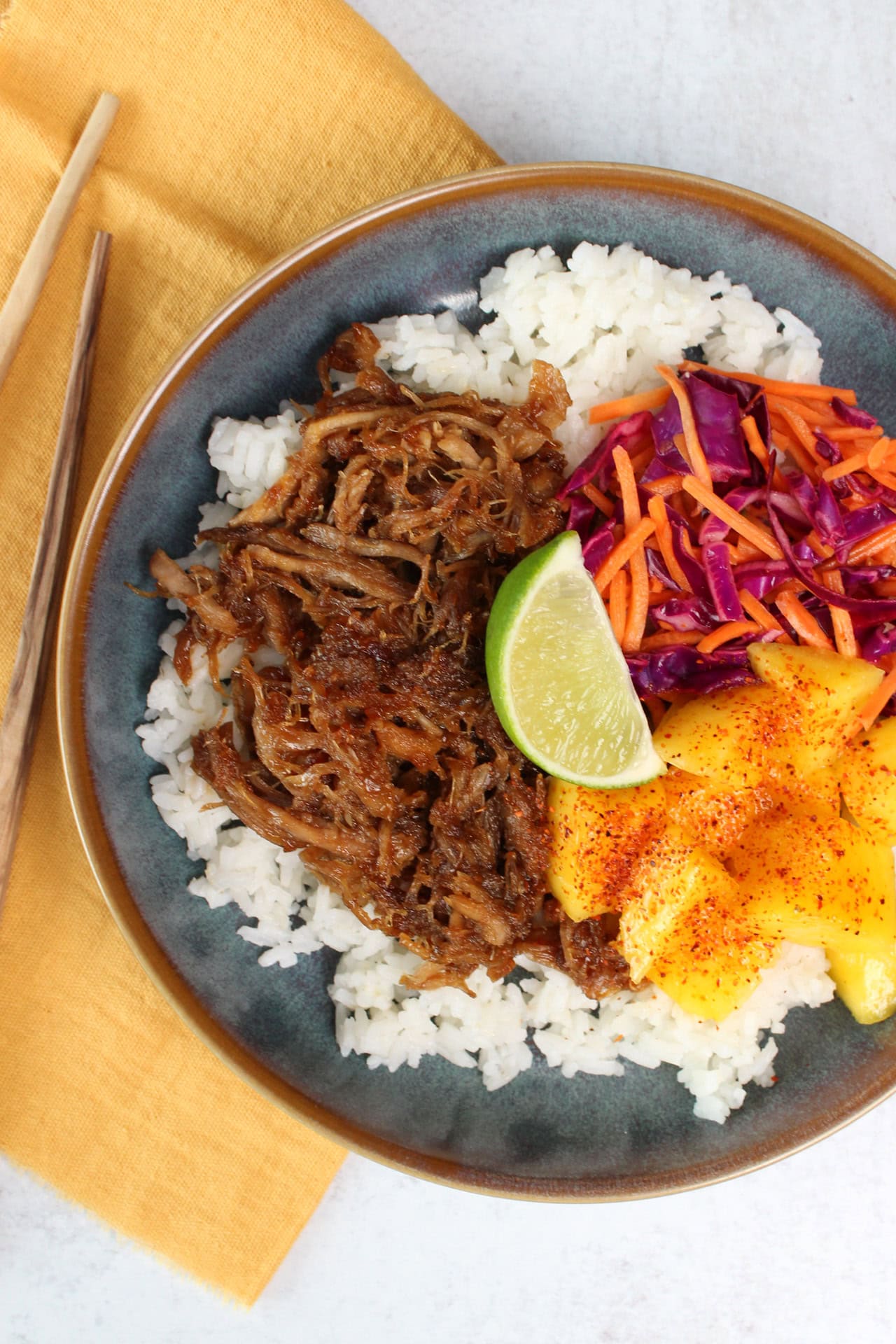 Hawaiian pulled pork bowl with rice and fresh mango.