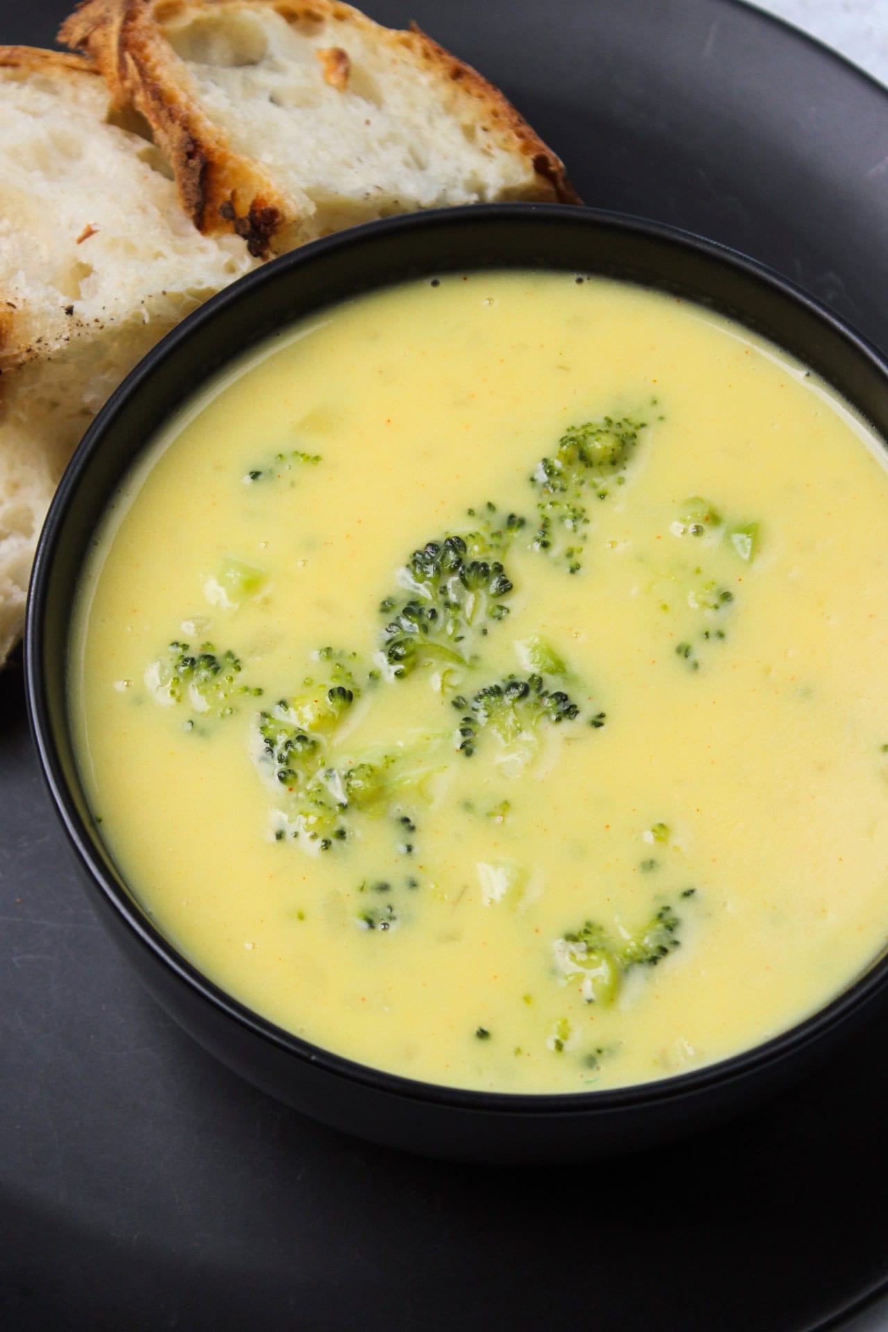A bowl of rich and creamy broccoli cheddar soup.