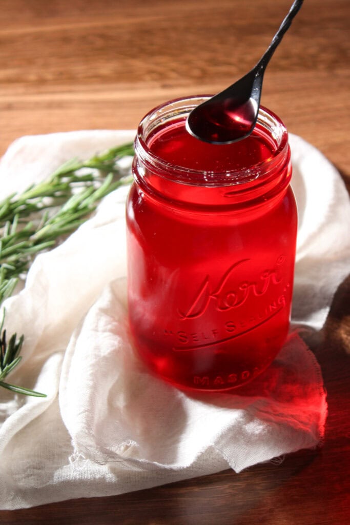 Simple syrup flavored with rosemary and cranberry.