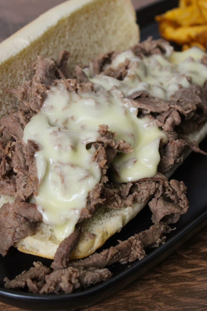 A closeup of a Philly cheesesteak.