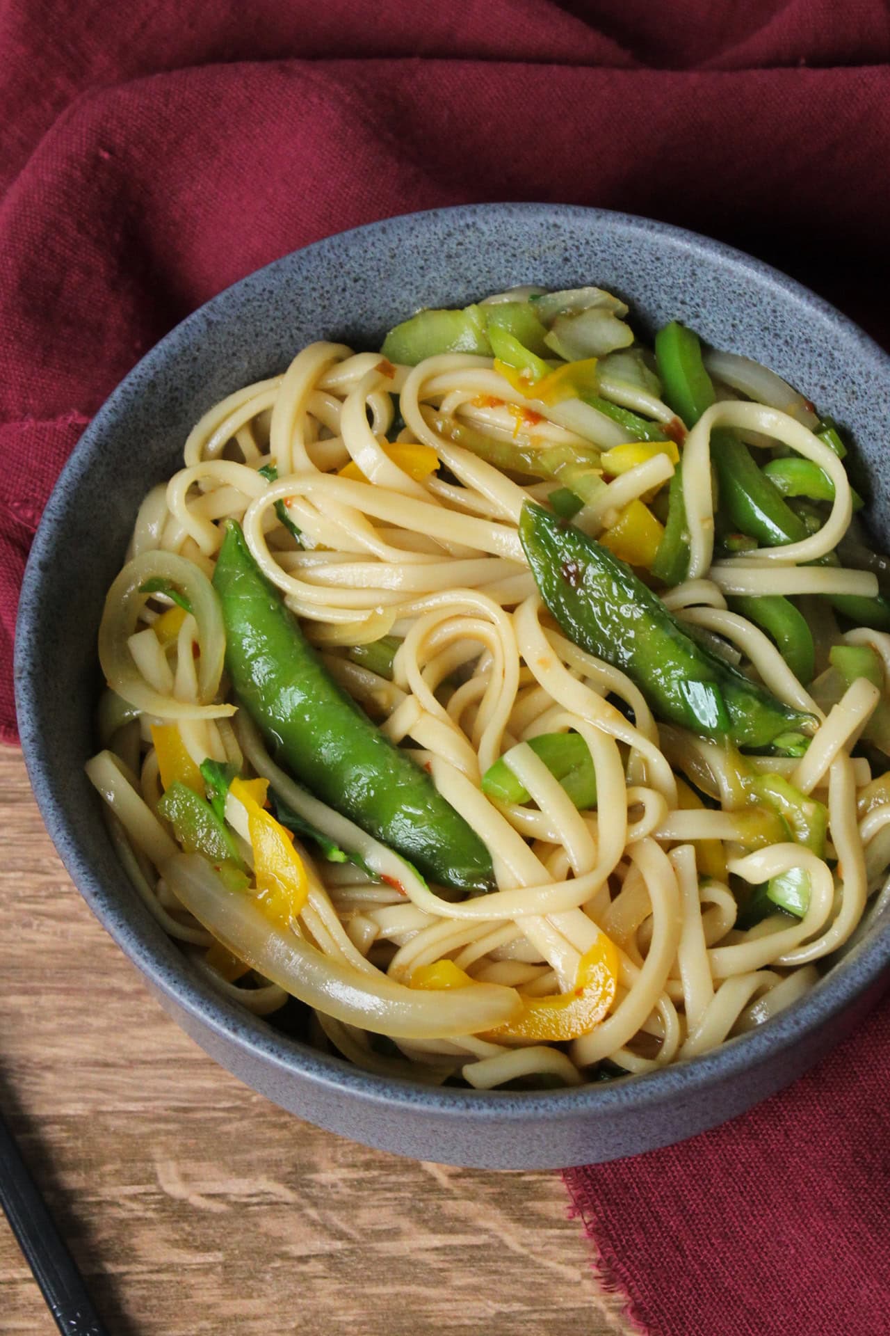 A vegetable stir fry with udon noodles.