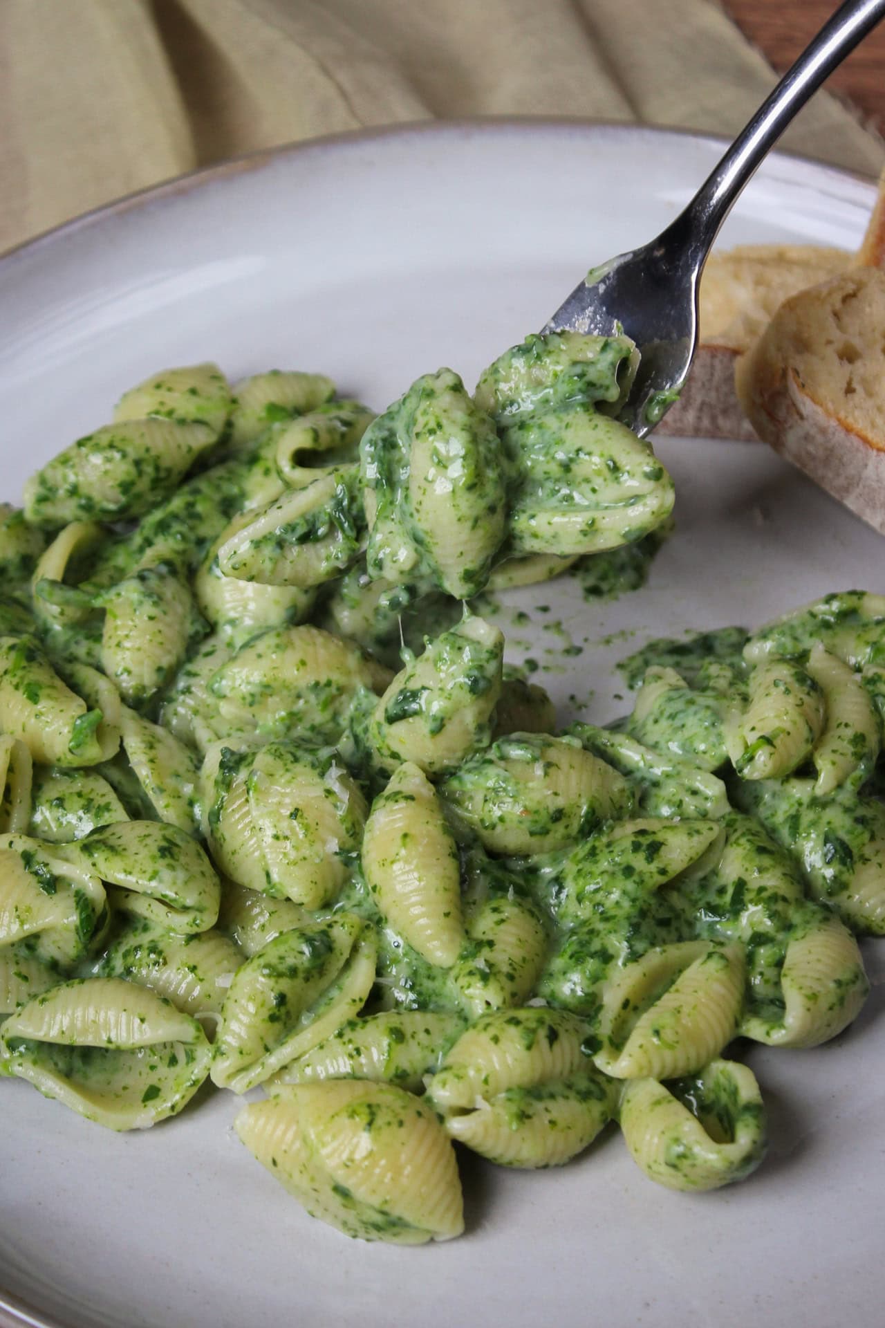 Pasta shells with spinach cottage cheese sauce.