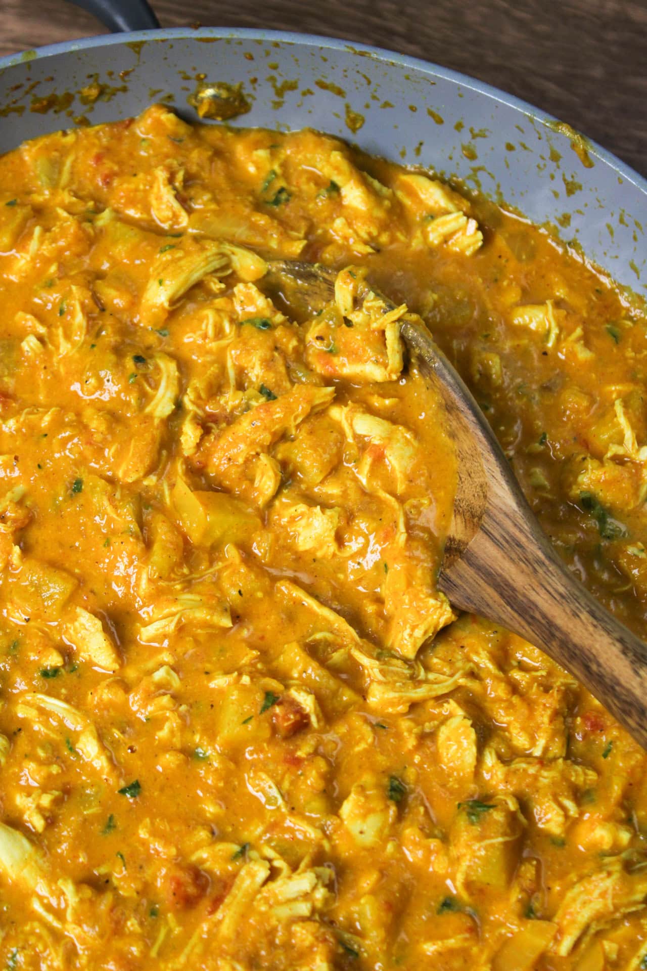 Pineapple curry with chicken cooking in a pan.