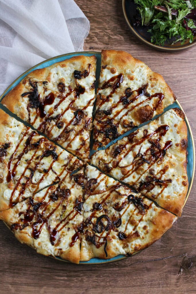 Burrata pizza with balsamic glaze drizzle and caramelized shallots.