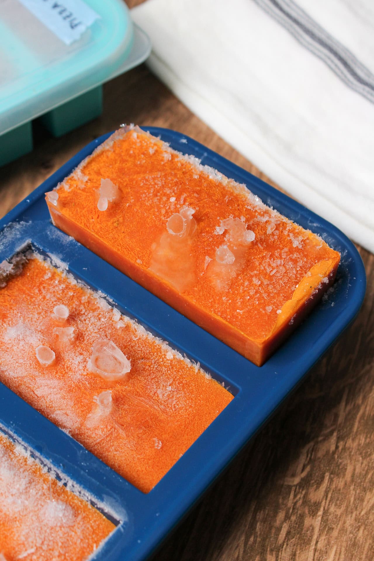 A frozen cube of tomato soup in Souper Cubes.