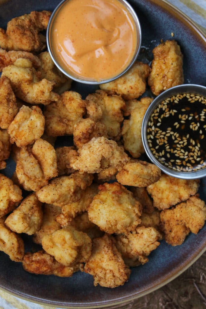 Popcorn chicken with sriracha aioli and sesame soy dip.