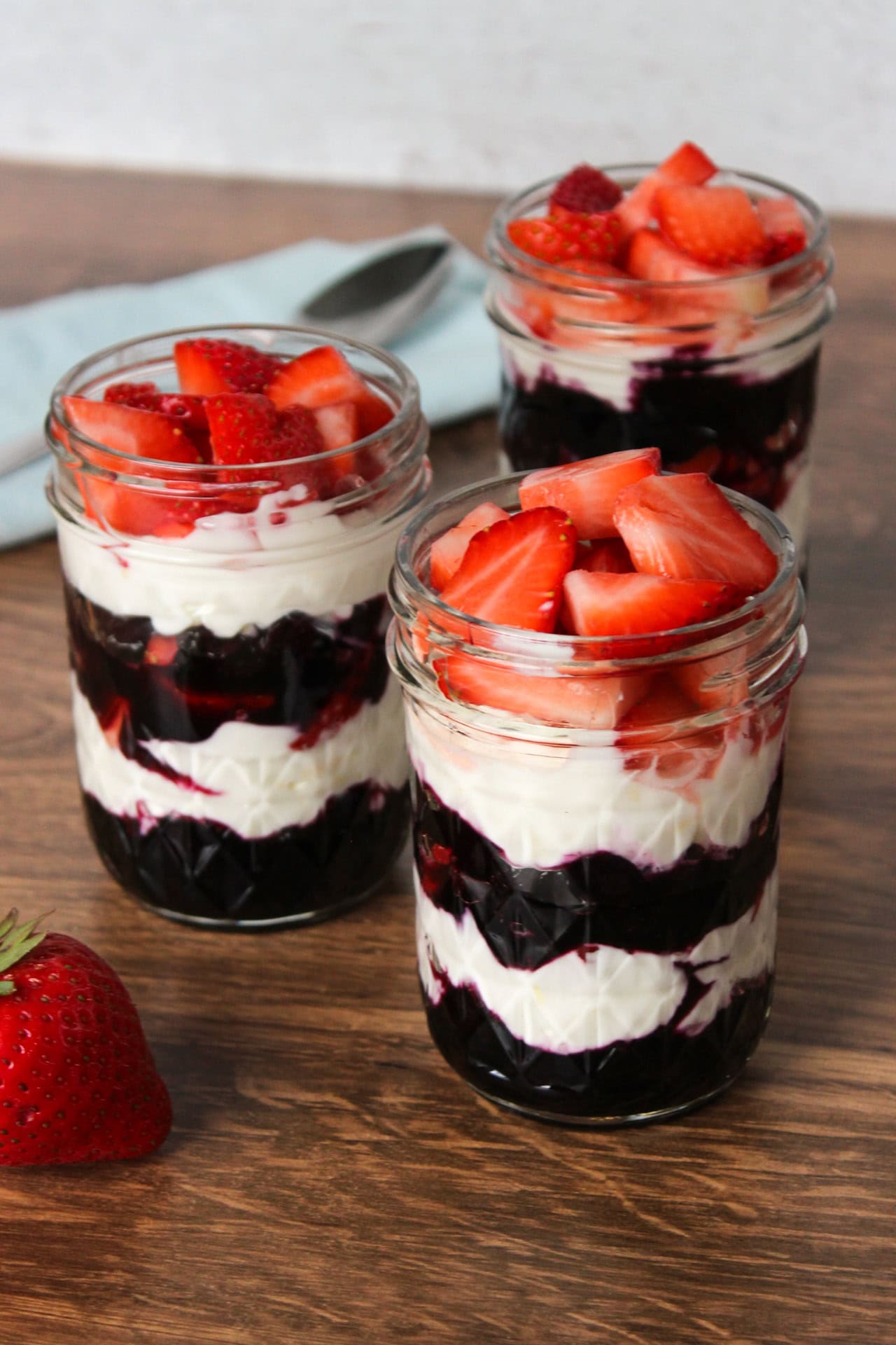 Dessert parfaits made with strawberries, blueberry compote, and Greek yogurt.