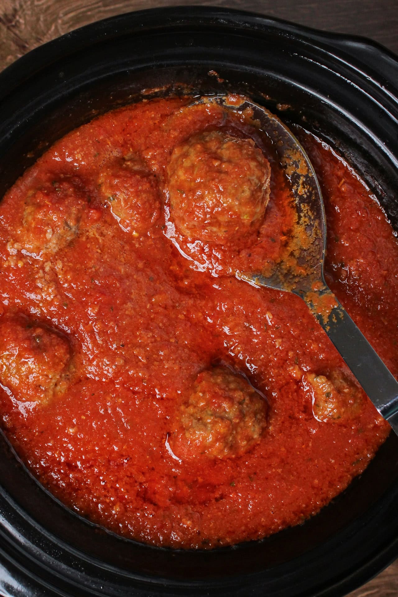 A crockpot of Italian meatballs and tomato sauce.