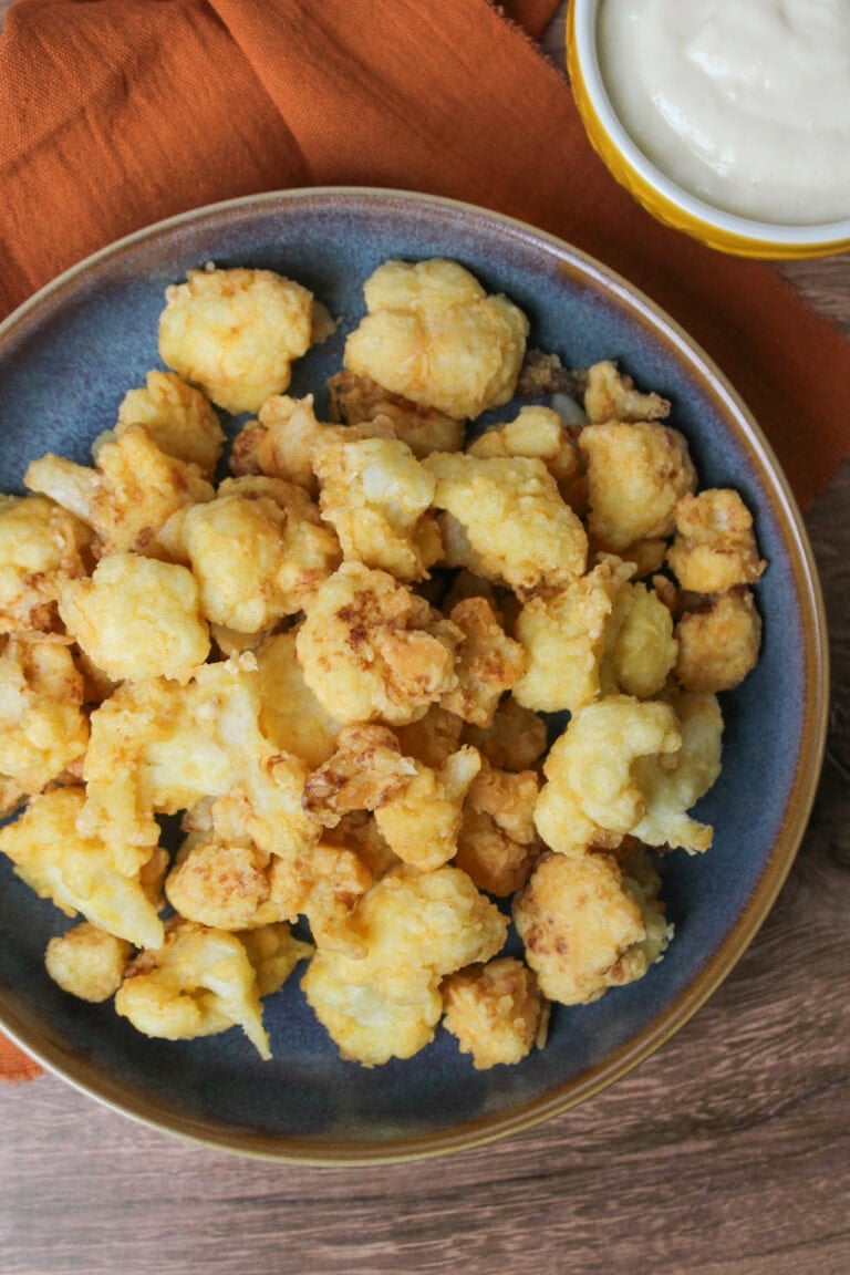A bowl of fried cauliflower florets.