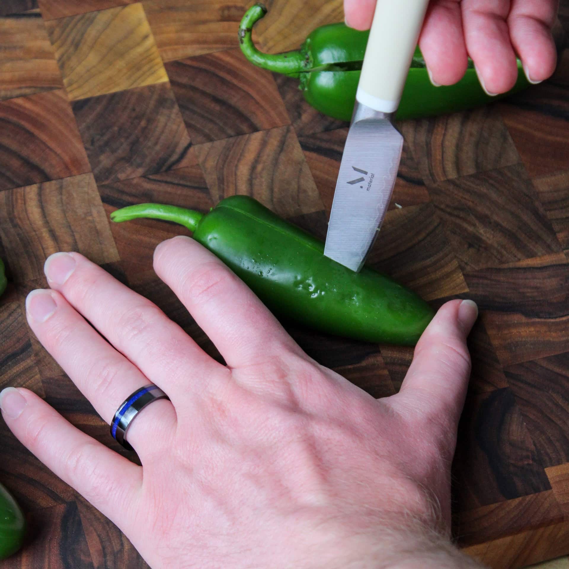 Cutting a slit into a jalapeno.
